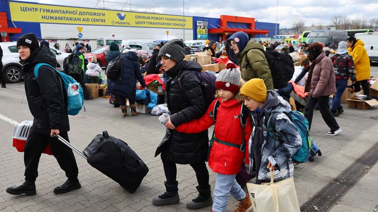 People fleeing the Russian invasion of Ukraine, arrive at a temporary accommodation and transport hub for refugees, in Przemysl, Poland, March 8, 2022. REUTERS/Fabrizio Bensch
