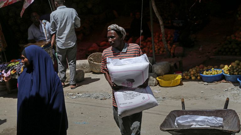 A man carries a sack of wheat flour imported from Turkey in the Hamar-Weyne market in the capital Mogadishu, Somalia Thursday, May 26, 2022. Families across Africa are paying about 45% more for wheat flour as Russia&#39;s war in Ukraine blocks exports from the Black Sea. Some countries like Somalia get more than 90% of their wheat from Russia and Ukraine. That&#39;s forcing many people to substitute wheat for other grains. But the United Nations is warning that the price hikes are coming as many parts of Africa are facing drought and hunger.  (AP Photo/Farah Abdi Warsameh)