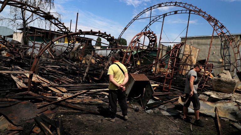 Workers inspect a damaged wood warehouse after a strike, amid Russia&#39;s attack on Ukraine, in the outskirt of Kharkiv, Ukraine June 3, 2022. REUTERS/Ivan Alvarado
