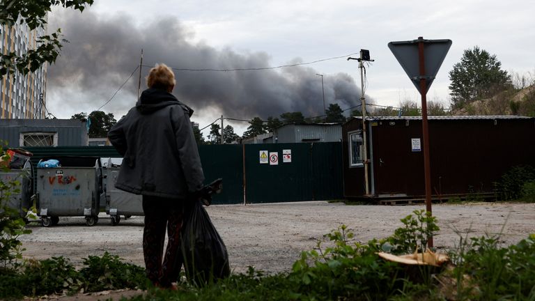 A man looks at the smoke after explosions were heard as Russia&#39;s attacks on Ukraine continues, in Kyiv, Ukraine June 5, 2022. REUTERS/Edgar Su
