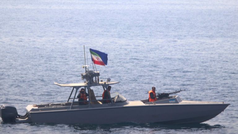 In this photo made available by the U.S. Navy, a boat of Iran&#39;s Islamic Revolutionary Guard Corps Navy (IRGCN) operates in close proximity to patrol coastal ship USS Sirocco (PC 6) and expeditionary fast transport USNS Choctaw County (T-EPF 2) in the Strait of Hormuz, Monday, June 20, 2022. A U.S. Navy warship fired a warning flare to wave off an Iranian Revolutionary Guard speedboat coming straight at it during a tense encounter in the strategic Strait of Hormuz, officials said Tuesday. (U.S. Navy via AP)