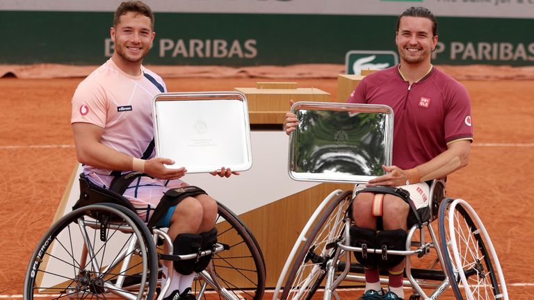 Alfie Hewett of Great Britain (L) and partner Gordon Reid of Great Britain celebrate with the trophy after winning against Gustavo Fernandez of Argentina and Shingo Kunieda of Japan during the Men&#39;s Wheelchair Doubles Final match on Day 15 of The 2022 French Open at Roland Garros on June 05, 2022 in Paris, France. (Photo by Clive Brunskill/Getty Images)