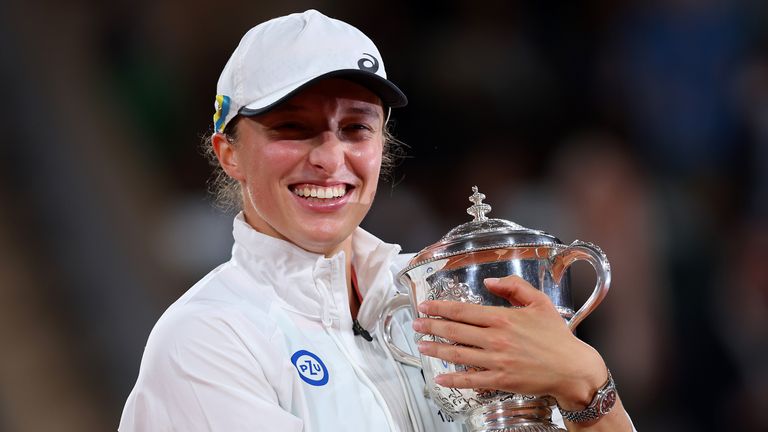 Iga Swiatek of Poland celebrates with the trophy after winning against Coco Gauff of The United States during the Women’s Singles final match on Day 14 of The 2022 French Open at Roland Garros on June 04, 2022 in Paris, France. (Photo by Clive Brunskill/Getty Images)