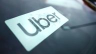 An Uber sign is displayed inside a car in Palatine, Ill., Thursday, Feb. 10, 2022.