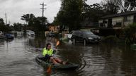 A kayaker paddles through a flooded residential area following heavy rains in the South Windsor suburb of Sydney, Australia, July 5, 2022. REUTERS/Loren Elliott
