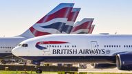 LONDON, ENGLAND - MARCH 2019: Boeing 777 long haul airliner operated by British Airways taxiing for take off at London Heathrow Airport past tail fins of the company&#39;s other aircraft.