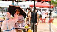A medical worker takes swab samples on residents during a campaign to screen the city's population for Covid-19 in Nanchang in central China's Jiangxi province Monday, July 18, 2022. The city reported 12 locally transmitted cases on Sunday. (FeatureChina via AP Images)