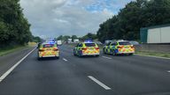 Police escort vehicles towards the Prince of Wales Bridge during the morning rush hour as drivers hold a go-slow protest on the M4