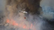A helicopter works on containing a wildfire during the second heatwave of the year in the vicinity of Guadapero
A helicopter works on containing a wildfire during the second heatwave of the year in the vicinity of Guadapero, Spain, July 15, 2022. REUTERS/Susana Vera