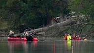 Teams in dry suits and Ramsey County Sheriff&#39;s deputies search for the bodies of a mother and her three children at Vadnais Lake, Saturday, July 2, 2022, in Vadnais Heights, Minn. The father of the children died at a different location hours earlier. (Anthony Souffle/Star Tribune via AP)