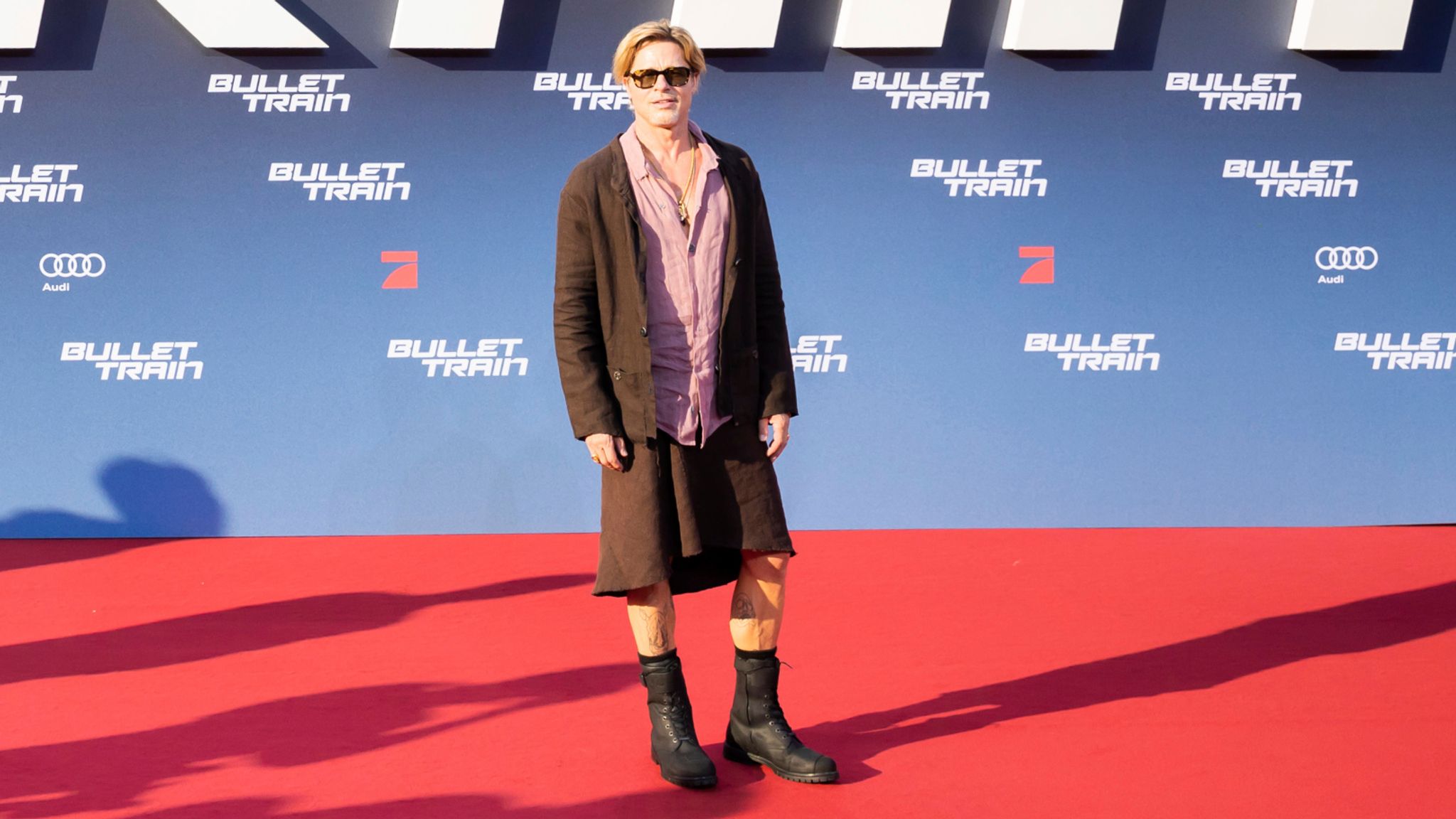 Brad Pitt beats the heat by rocking a skirt to premiere of new movie | Ents  & Arts News | Sky News