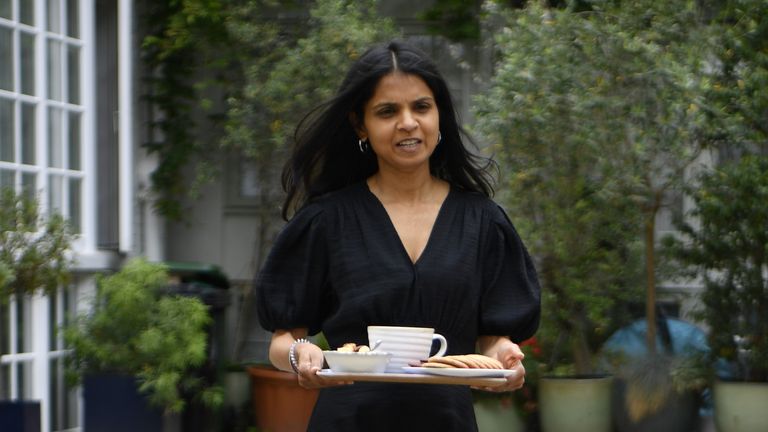 Akshata Murthy, wife of former Chancellor of the Exchequer Rishi Sunak, hands out tea to the waiting media outside their home in central London following his resignation on Tuesday. Picture date: Wednesday July 6, 2022.
