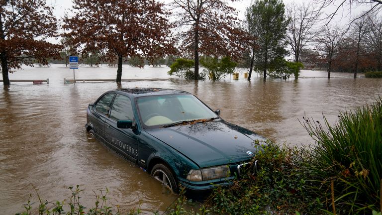 A car is half-submerged in flood water in Camden, on the outskirts of Sydney.  Photo: AP
