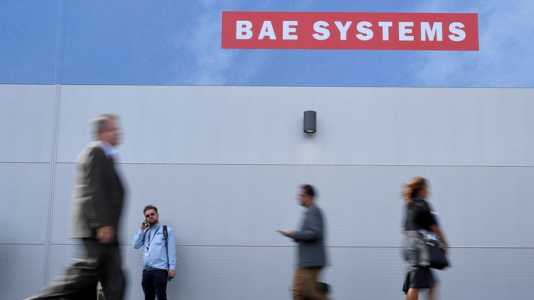 Trade visitors walk past an advertisement for BAE Systems at Farnborough International Airshow in Farnborough, Britain, July 17, 2018. REUTERS/Toby Melville/File Photo