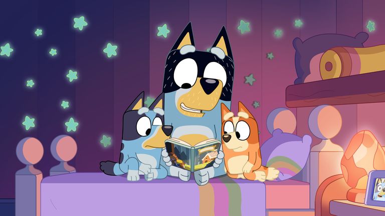 Dad finishes reading a bedtime story to Bluey and Bingo. Pic: BBC