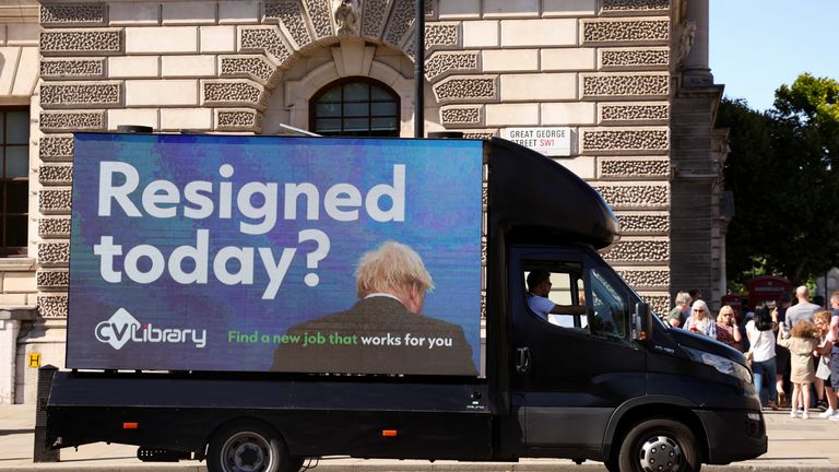 A mobile advertising board featuring Boris Johnson drives near Downing Street