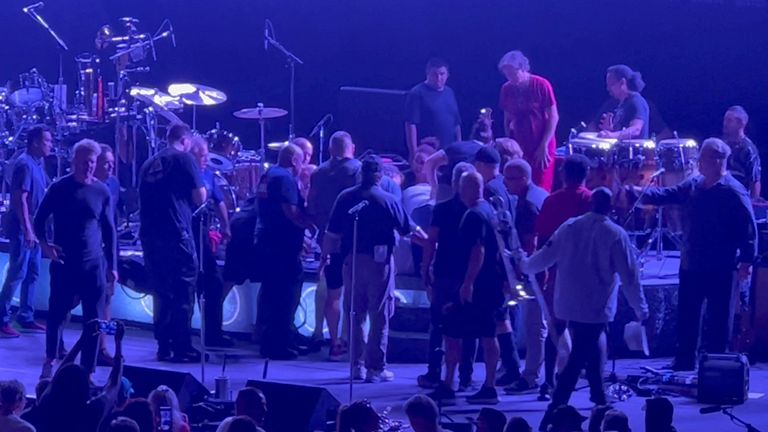 Medical personnel and other people attend to guitarist Carlos Santana after he fainted while performing on the stage during a show at the Pine Knob Music Theatre in Clarkston, Michigan, U.S., July 5, 2022 in this screen grab obtained from a social media video. Rick Notter/via REUTERS THIS IMAGE HAS BEEN SUPPLIED BY A THIRD PARTY. MANDATORY CREDIT. NO RESALES. NO ARCHIVES.