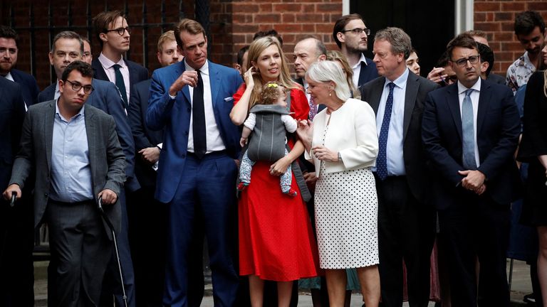 Carrie Johnson with her baby and British Culture Secretary Nadine Dorries listen as British Prime Minister Boris Johnson makes a statement at Downing Street in London, Britain, July 7, 2022. REUTERS/Peter Nicholls