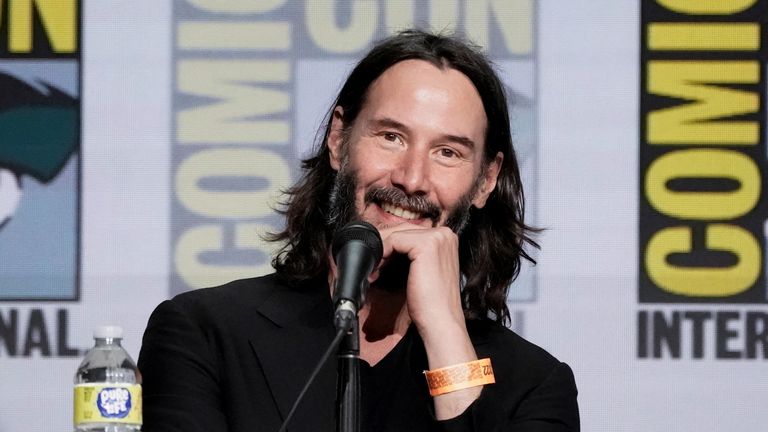 Keanu Reeves smiles during a panel on his comic book series, BRZRKR, in Hall H at Comic-Con International in San Diego, California, U.S., July 22, 2022. REUTERS/Bing Guan