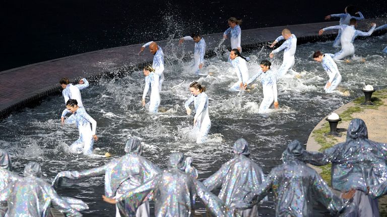 Performers dance in a water soaked stage during the opening ceremony of the Birmingham 2022 Commonwealth Games at the Alexander Stadium, Birmingham. Picture date: Thursday July 28, 2022.