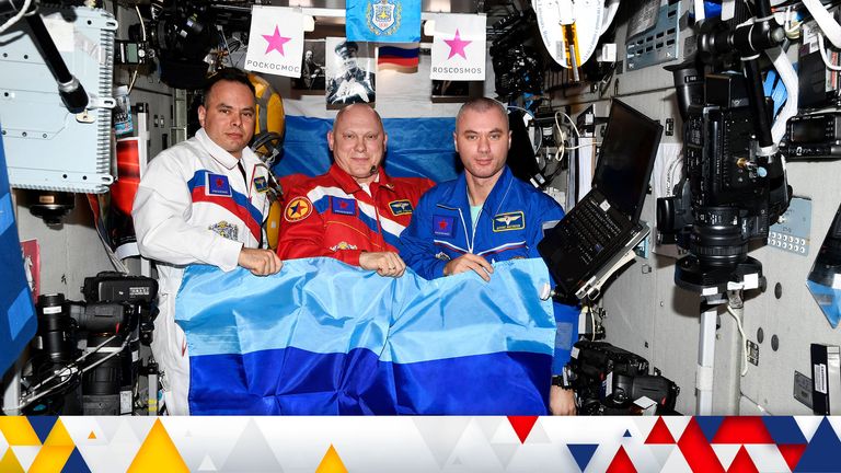 Russian cosmonauts Oleg Artemyev, Denis Matveev and Sergey Korsakov pose with a flag of the self-proclaimed Luhansk People&#39;s Republic at the International Space Station (ISS), in this picture released July 4, 2022. Roscosmos/Handout via REUTERS ATTENTION EDITORS - THIS IMAGE HAS BEEN SUPPLIED BY A THIRD PARTY. MANDATORY CREDIT.