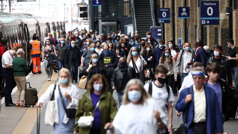 People wearing protective face masks walk along a platform at King&#39;s Cross Station, amid the coronavirus disease (COVID-19) outbreak in London, Britain, July 12, 2021. REUTERS/Henry Nicholls
