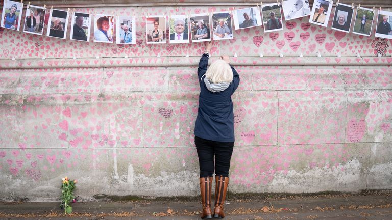 A family member pays their respects to those who lost their lives to Covid 19 as they mark the one-year anniversary of National Covid Memorial Wall, London. Picture date: Tuesday March 29, 2022.
