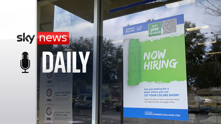 A Now Hiring sign advertising job openings is viewed outside a Sherwin-Williams paint store.