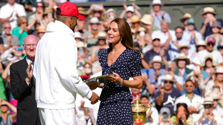 Britain's Kate, Duchess of Cambridge presents the runners-up trophy to Australia's Nick Kyrgios in the final of the men's singles against Serbia's Novak Djokovic on day fourteen of the Wimbledon tennis championships in London, Sunday, July 10, 2022. (AP Photo/Kirsty Wigglesworth)