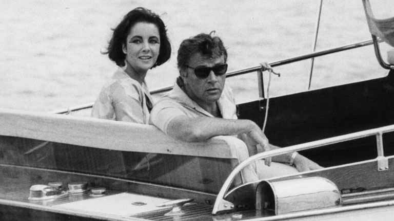 FILE - In this June 15, 1962 file photo, Richard Burton and Elizabeth Taylor arrive in a motor launch at the small town Porto d&#39;Ischia, on the isle of Ischia in the Gulf of Naples, Italy for the shooting of some scenes of "Cleopatra". Publicist Sally Morrison says Taylor died Wednesday, March 23, 2011 in Los Angeles of congestive heart failure at age 79. (AP Photo/Girolamo, File)