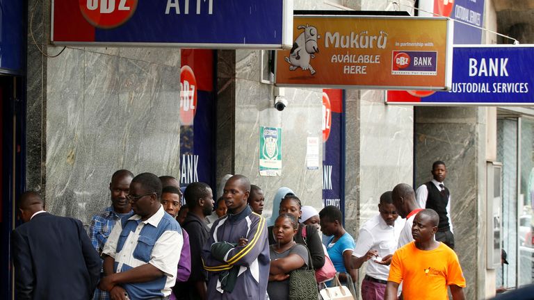 FILE PHOTO: Zimbabweans queue outside a bank in Harare, Zimbabwe, February 26, 2019. REUTERS/Philimon Bulawayo/File Photo
