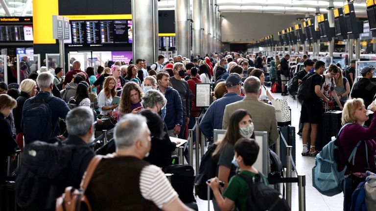 FILE PHOTO: Passengers queue inside the departures terminal of Terminal 2 at Heathrow Airport in London, Britain, June 27, 2022. REUTERS/Henry Nicholls/File Photo

