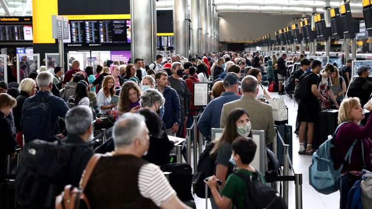 FILE PHOTO: Passengers line up inside the departures terminal of Terminal 2 at Heathrow Airport in London, Britain, June 27, 2022. REUTERS/Henry Nicholls/File Photo