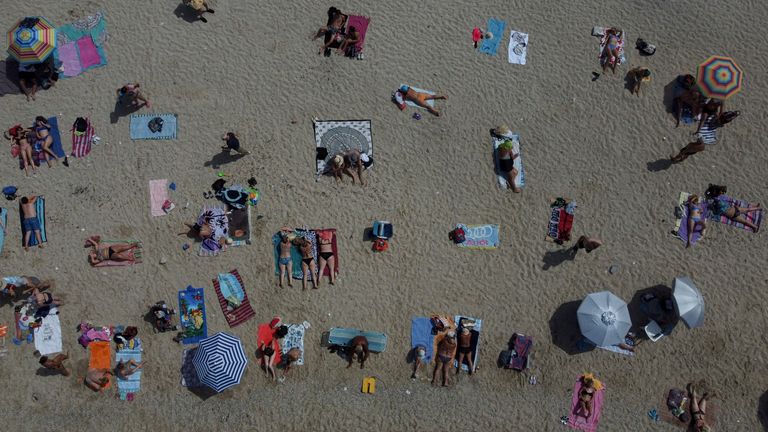 People gather at the public beach of Alimos in southern Athens, Greece, Thursday, June 23, 2022. Temperatures reached 40..C (104..F) in parts of southern Greece on Friday as a June heatwave swept across central Europe.  High temperatures and drought in parts of the continent have raised concerns about the risk of wildfires.  (AP Photo/Thanasis Stavrakis)