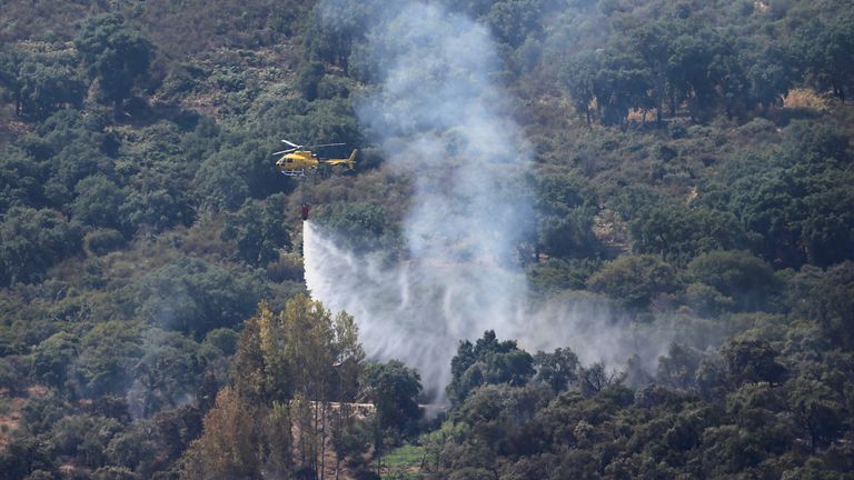 Wildfire rages as Spain experiences its second heatwave of the year
A helicopter works on containing a wildfire during the second heatwave of the year in the vicinity of Casas de Miravete, Spain, July 16, 2022. REUTERS/Isabel Infantes