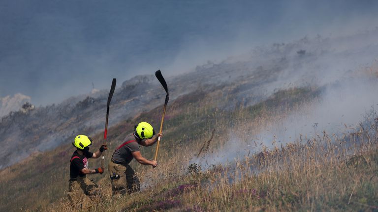 Firefighters attend a gorse bush fire, during a heatwave near Zennor, Cornwall, Britain, July 19, 2022. REUTERS/Tom Nicholson
