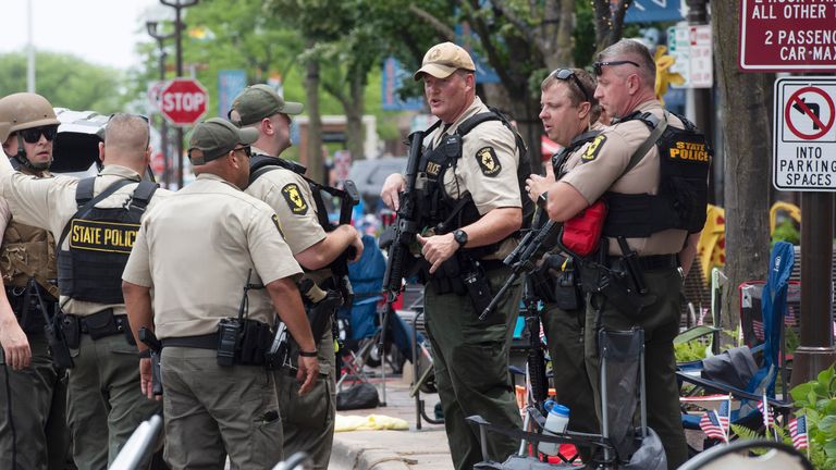 Officers from the Illinois State Police confer near the scene of a shooting involving multiple victims that took place at the Highland Park, Ill., Fourth of July parade Monday, July 4, 2022. (Joe Lewnard/Daily Herald via AP)
PIC:Ap