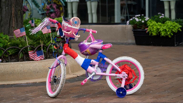 A child&#39;s bicycle is left behind on Central Avenue near the scene of a mass shooting at a Fourth of July parade route in the wealthy Chicago suburb of Highland Park, Illinois, U.S. July 4, 2022. REUTERS/Max Herman
