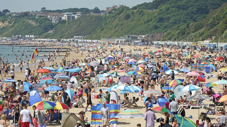 People relax in the hot weather on Bournemouth beach in Dorset. A sweltering 34C (93.2F) is expected in London and potentially some spots in East Anglia on Friday, according to the Met Office. Picture date: Friday June 17, 2022.