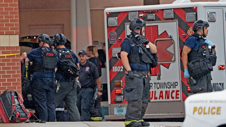 Law enforcement waits outside following the deadly shooting Sunday, July 17, 2022, at Greenwood Park Mall, in Greenwood, Ind.  (Kelly Wilkinson / The Indianapolis Star via AP)