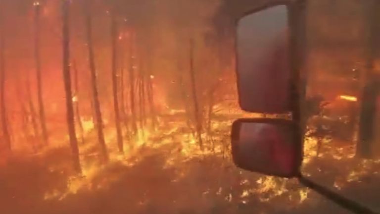Firefighters drive through raging inferno
