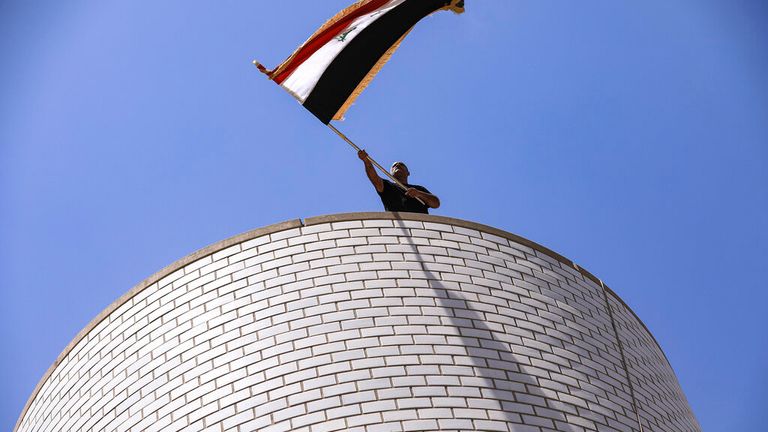 A man waving the Iraqi flag during the protests Pic: AP 