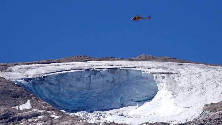 A search helicopter is seen above the Marmolada glacier in the Italian Alps