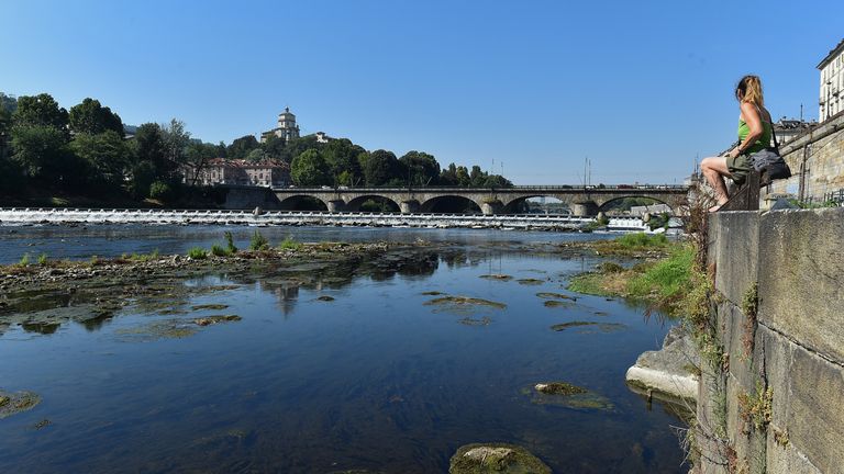 Drought-stricken northern Italy suffers a second summer heatwave A woman sits beside the dry riverbed of Po, as part of Italy's longest river dries up due to the worst drought for the past 70 years, in Turin, Italy July 15, 2022. REUTERS / Massimo Pinca