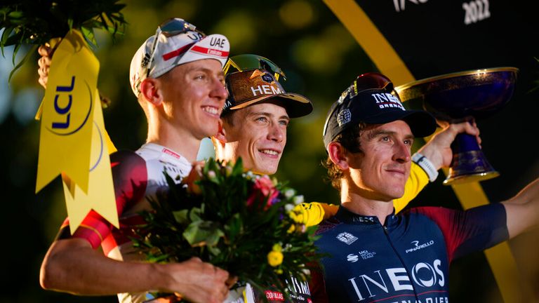 Tour de France Denmark champion Jonas Vingegaard, wearing the overall leader's yellow jersey, second-place Slovenian Tadej Pogacar, left, and third-place British Geraint Thomas, right, celebrate on the podium after stage 21 of the more than 116 km (72 mi) Tour de France cycling race that begins at Paris la Defense Arena and ends on the Champs Elysees in Paris, France, Sunday, July 24 2022. (AP Photo / Daniel Cole)