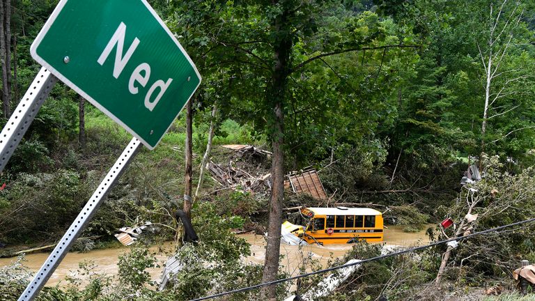 A Perry County school bus lies destroyed after being caught up in the floodwaters of Lost Cree in Ned, Ky., Friday, July 29, 2022. (AP Photo/Timothy D. Easley)