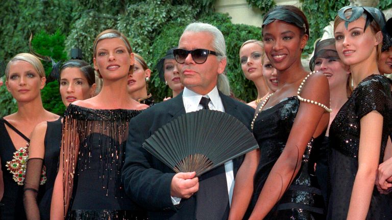 German designer  Karl Lagerfeld  is surrounded by Canadian model Linda Evangelista, left,  and British  model Naomi Campbell, right, and other models after the presentation of his 1996-97 fall-winter  haute couture fashion collection  for Chanel in Paris Tuesday July 9, 1996.(AP Photo/Lionel Cironneau)