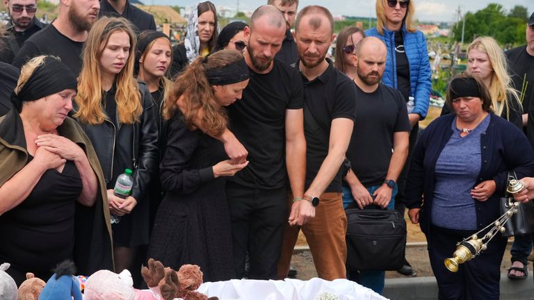 Relatives and friends react near the coffin during a funeral ceremony for Liza, 4-year-old girl killed by Russian attack, in Vinnytsia, Ukraine, Sunday, July 17, 2022. Wearing a blue denim jacket with flowers, Liza was among 23 people killed, including 2 boys aged 7 and 8, in Thursday&#39;s missile strike in Vinnytsia. Her mother, Iryna Dmytrieva, was among the scores injured. (AP Photo/Efrem Lukatsky)
