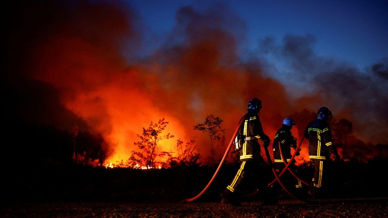 Firefighters work to contain a tactical fire in Louchats, as forest fires continue to spread in the Gironde region of southwestern France.