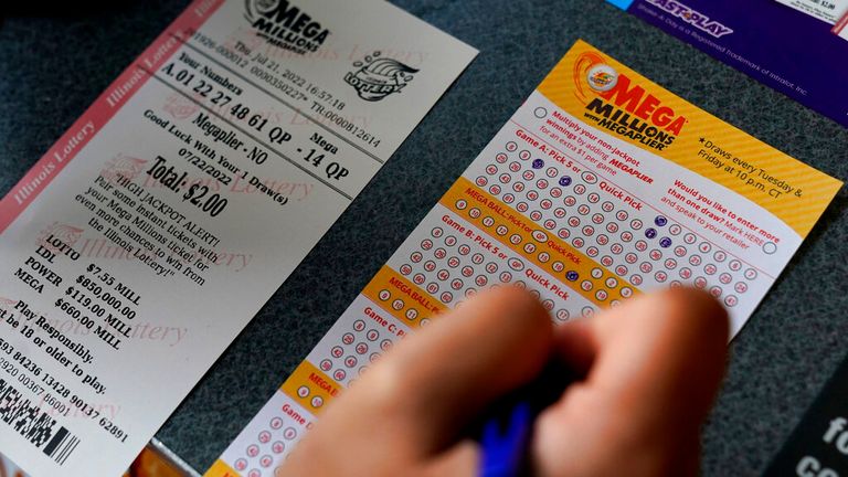 A customer fills out a Mega Millions lottery ticket at a convenience store in Northbrook. Pic: AP
